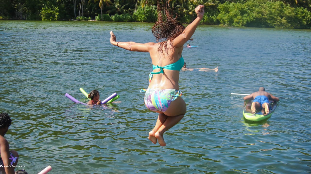 Woman jumping into water.