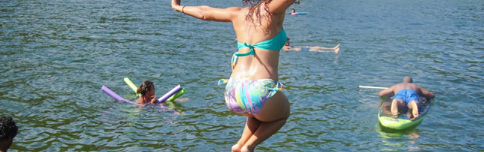 Woman jumping into water.