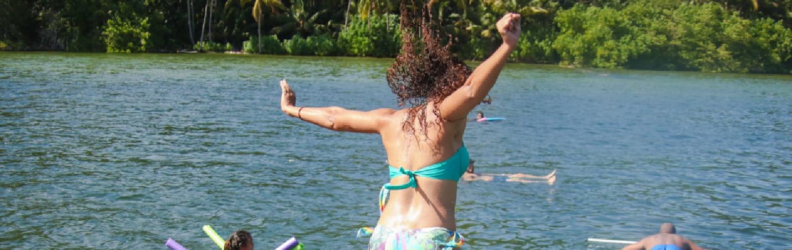 Woman jumping into water.
