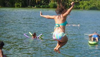 Woman jumping into water.